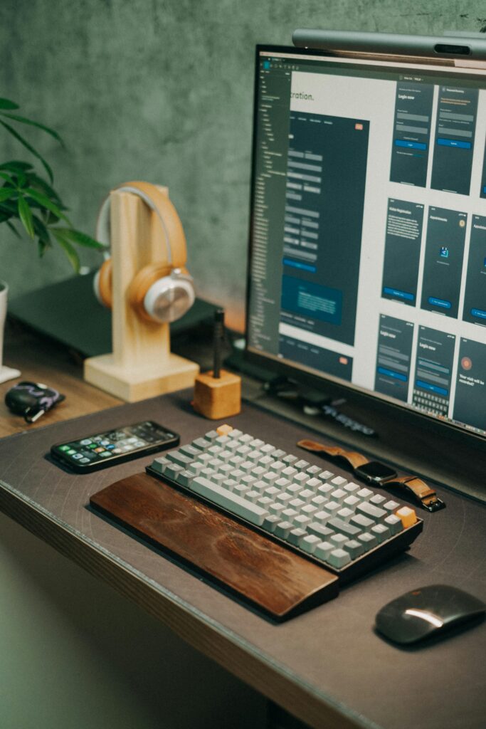 pexels-photo-13162095-13162095 Stylish desktop setup featuring screen, keyboard, mouse, and headphones for a tech-savvy workspace.